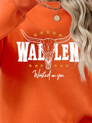 Orange graphic sweatshirt with bull skull and text detail