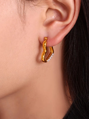 Gold wave hoop earrings with white bead accents