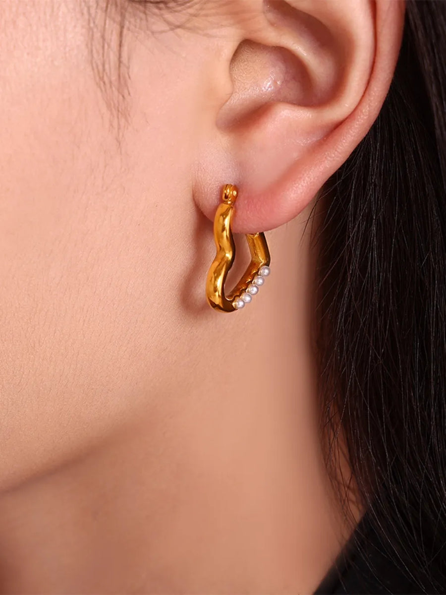 Gold wave hoop earrings with white bead accents