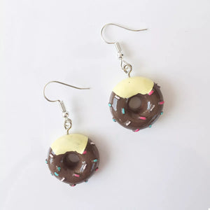 Dark brown donut dangle earrings with yellow icing and colorful sprinkles.