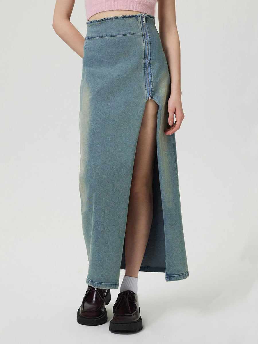 Denim maxi skirt in medium wash with a high waist and front zipper slit.