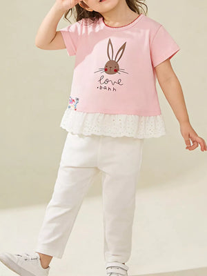 Pink cotton crew neck tee with bunny graphic and white eyelet ruffle hem.