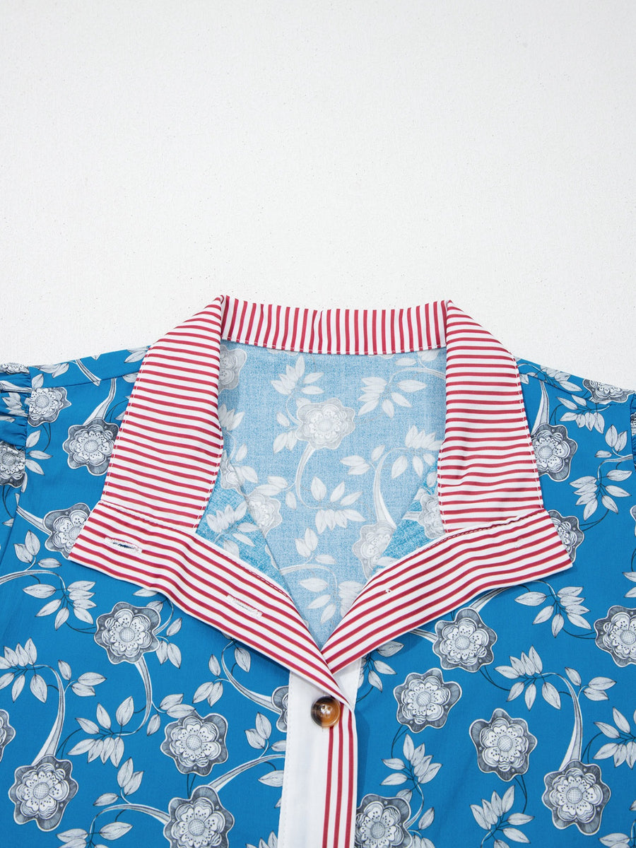 Blue floral cotton blouse with red and white striped collar and button detail.