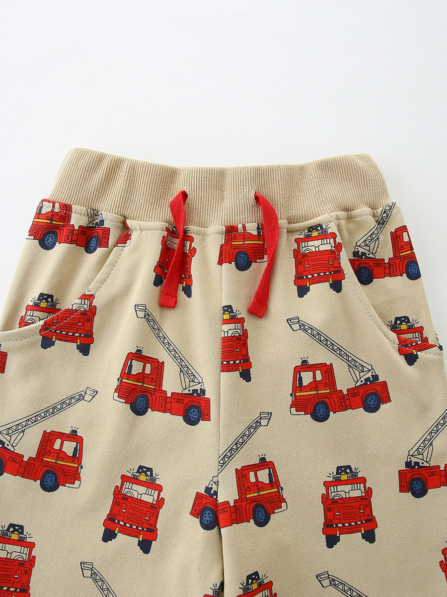 Boys' beige cotton underwear with allover red firetruck print and red drawstring.