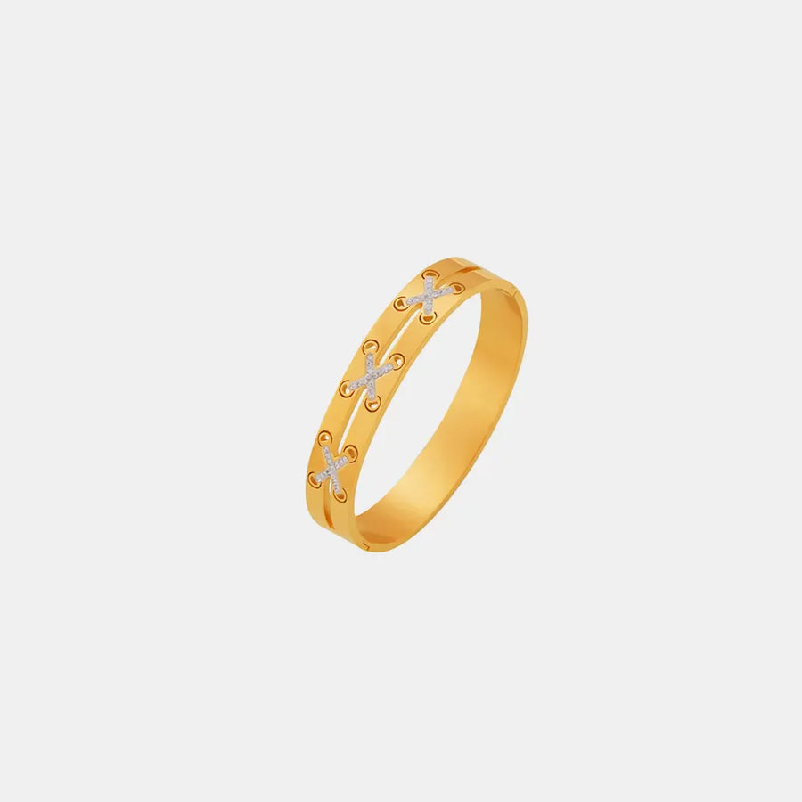 Gold cuff bracelet with diamond laced crisscross detail