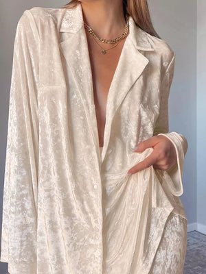 95% polyester, 5% elastane Care instructions: Machine wash cold lounge set in ivory with relaxed silhouette