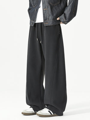 Men's black relaxed fit sweatpants with drawstring and diagonal seam detail