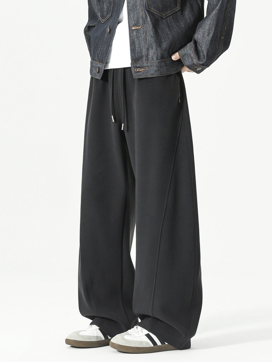 Men's black relaxed fit sweatpants with drawstring and diagonal seam detail