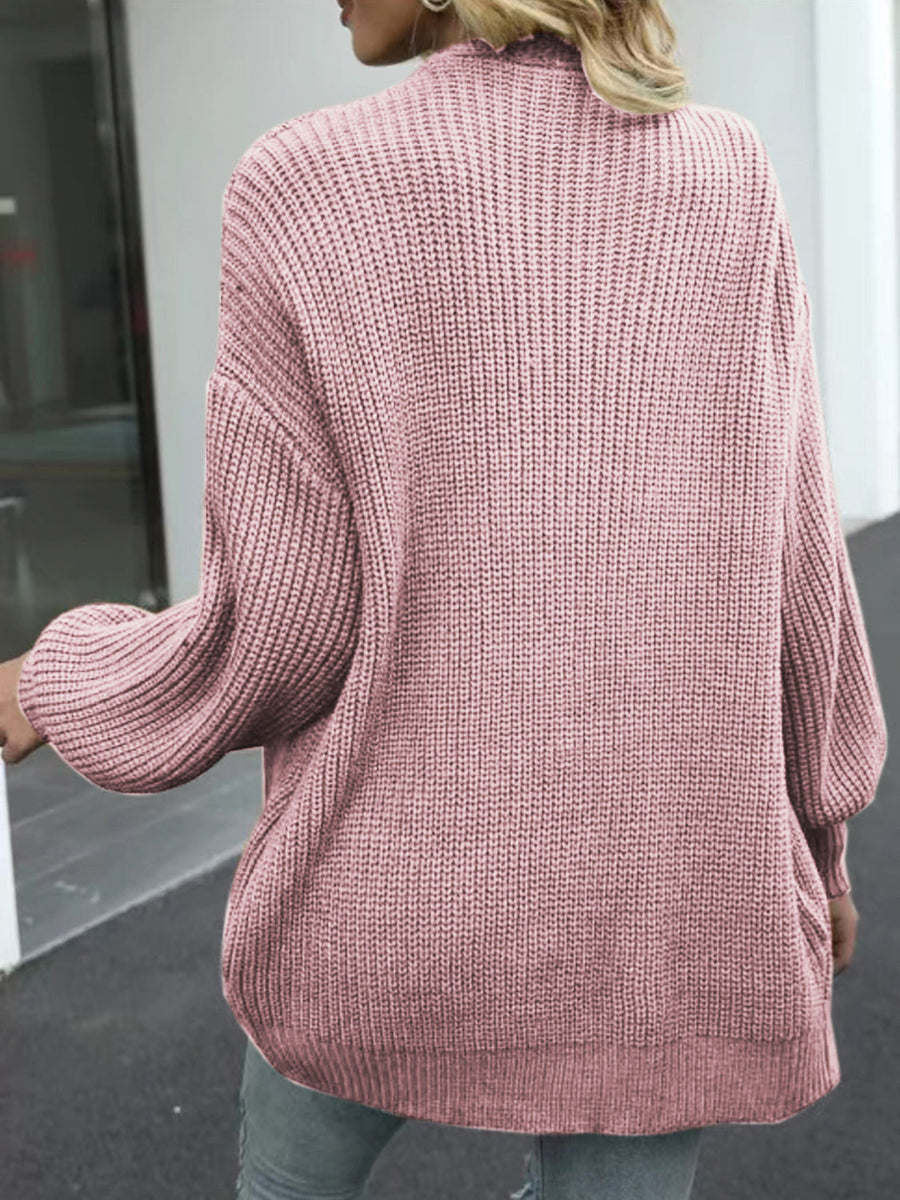 Dusty pink chunky knit cocoon cardigan with balloon sleeves and ribbed texture.