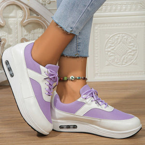 Purple and white lace-up wedge sneakers with breathable mesh and air cushioning.