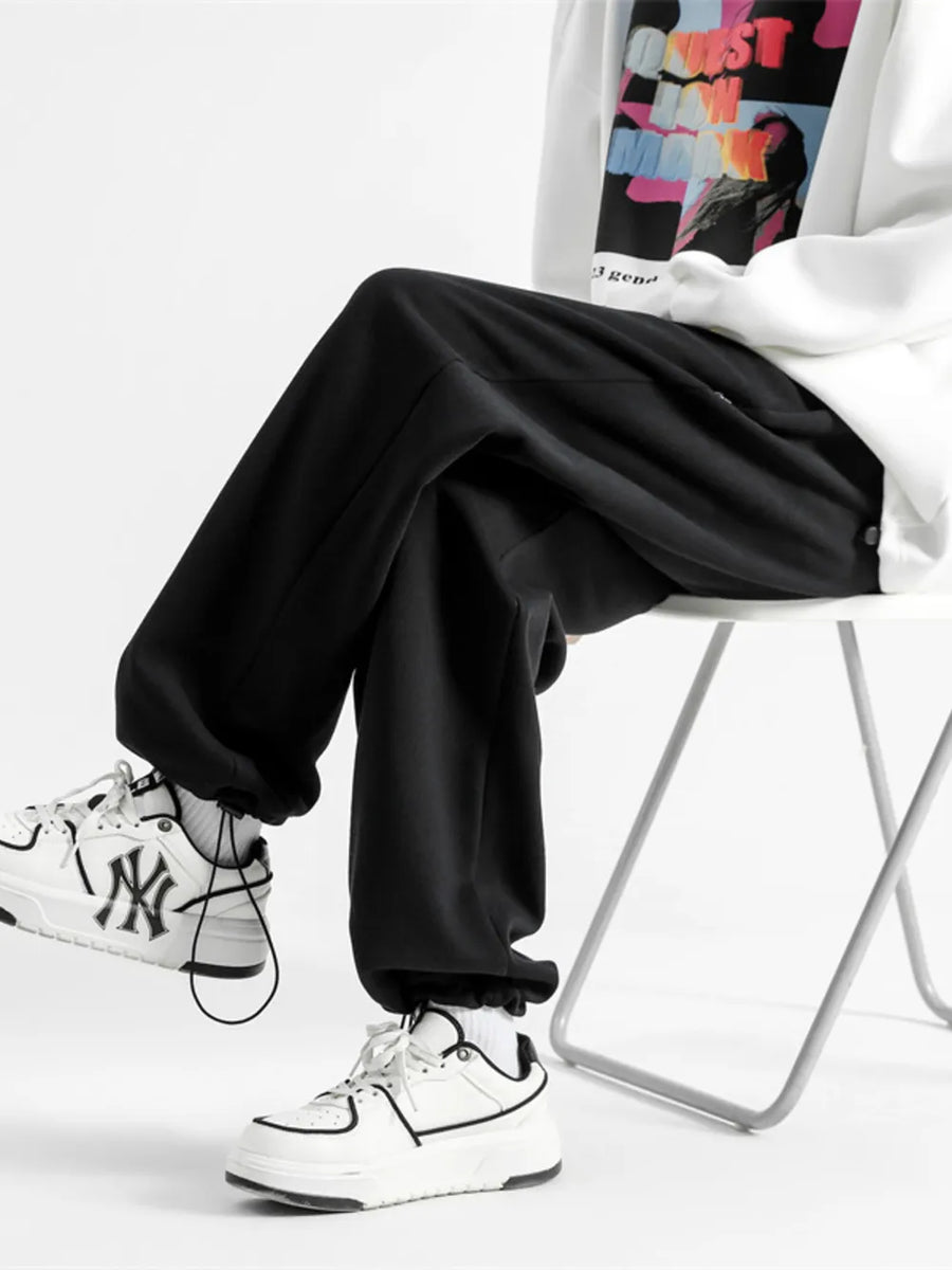 Black relaxed fit drawstring wide-leg sweatpants with cuffed ankles.