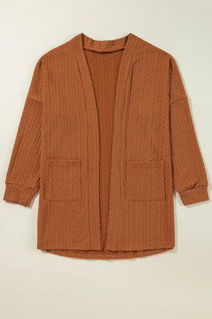 Terracotta open front cardigan with cable knit texture and two front pockets.