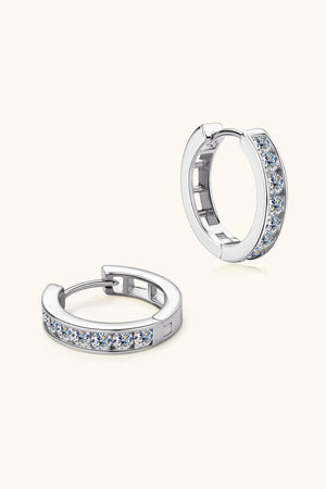 Silver moissanite channel-set hoop earrings with sparkling stones.
