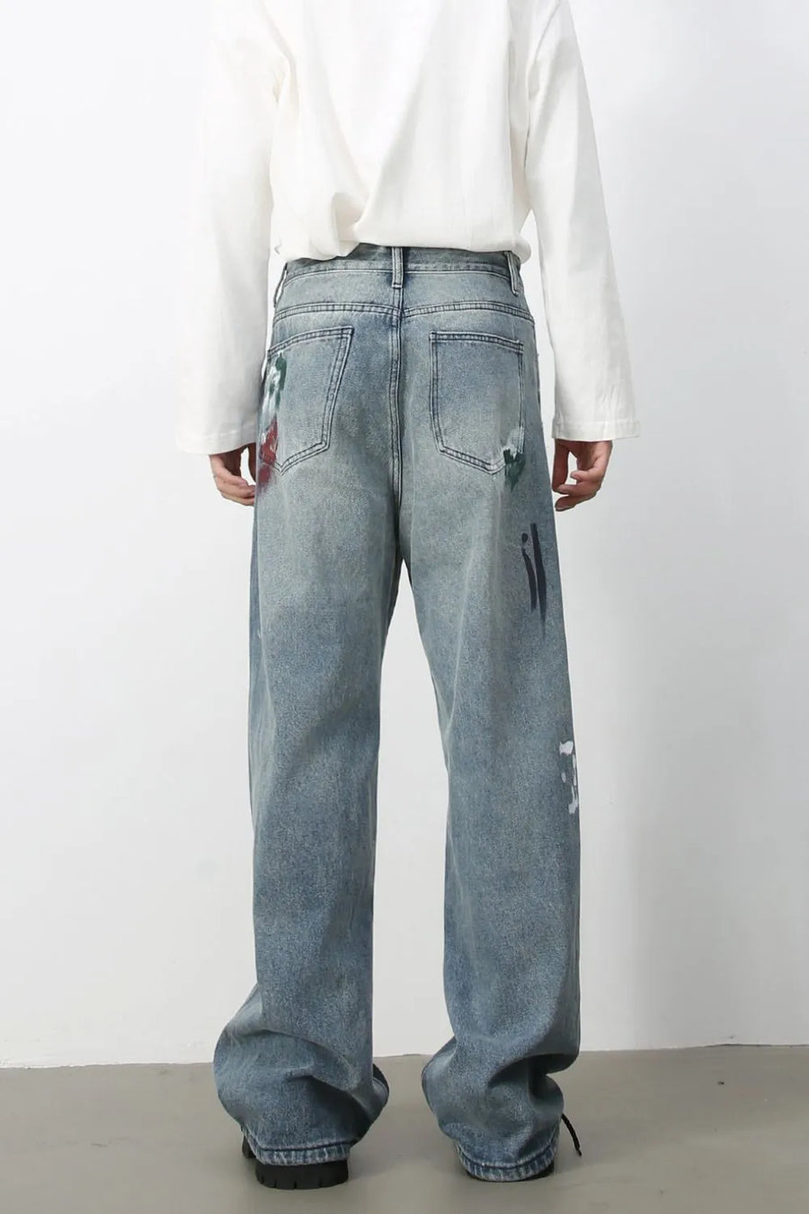 Ink-Blot Wide Leg Denim jeans in medium wash feature abstract paint splatters and artistic details.