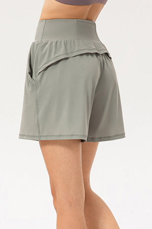 Sage active shorts with layered pockets and a high-rise waist