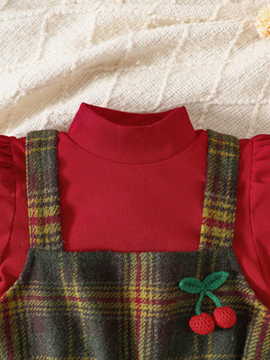 Baby girls' red turtleneck top with plaid jumper dress featuring cherry applique.