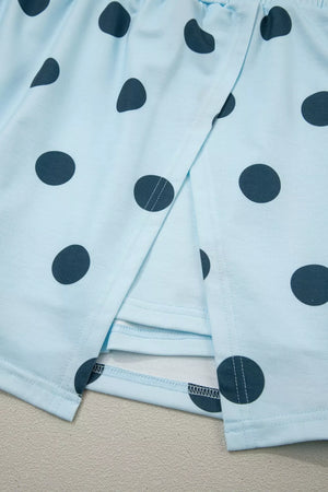 Pastel blue polka dot skort with wrap detail and contrast stitching.