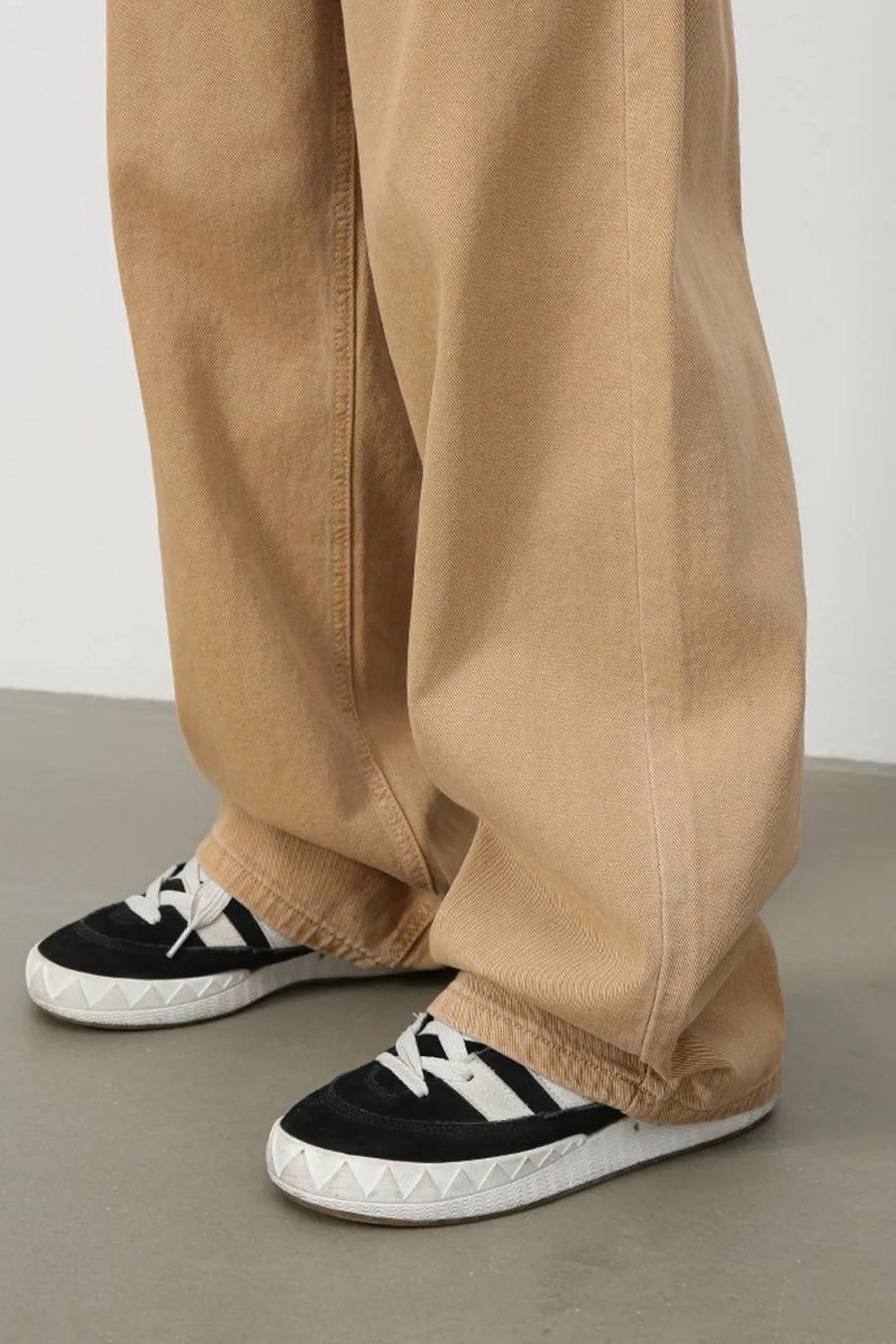 Wide-leg khaki denim trousers with a relaxed fit and visible stitching detail.
