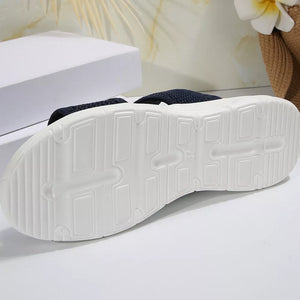 Dark blue mesh sandals with a white sole and textured tread.