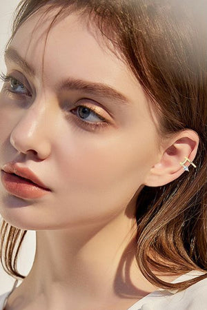 Gold ear cuff with a spiral diamond detail on a woman's ear