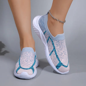 Geometric knit slip-on trainers in light gray with blue accents and white soles.