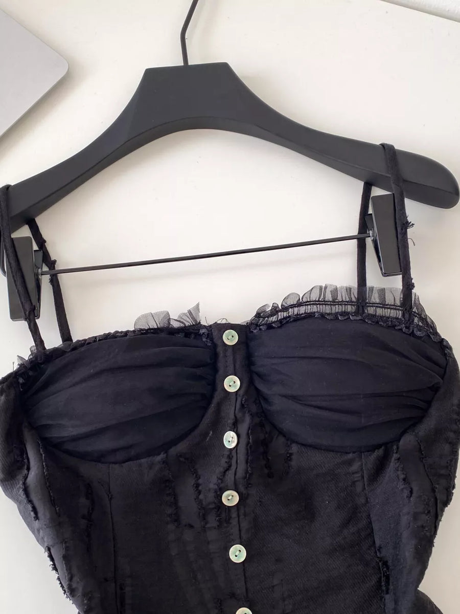 Black lace ruffle hem tank top with button front and sheer bust detail.