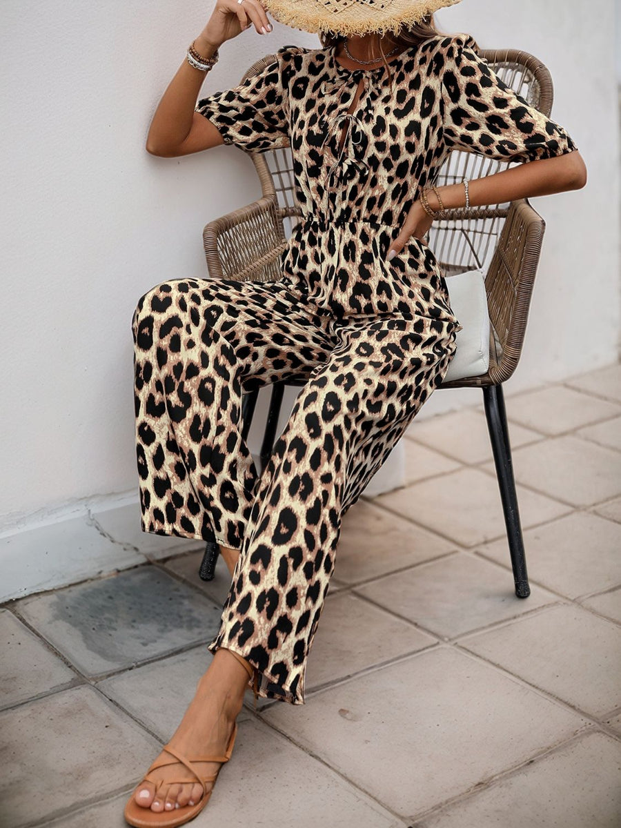 Leopard print puff sleeve jumpsuit with tie neck and wide legs.