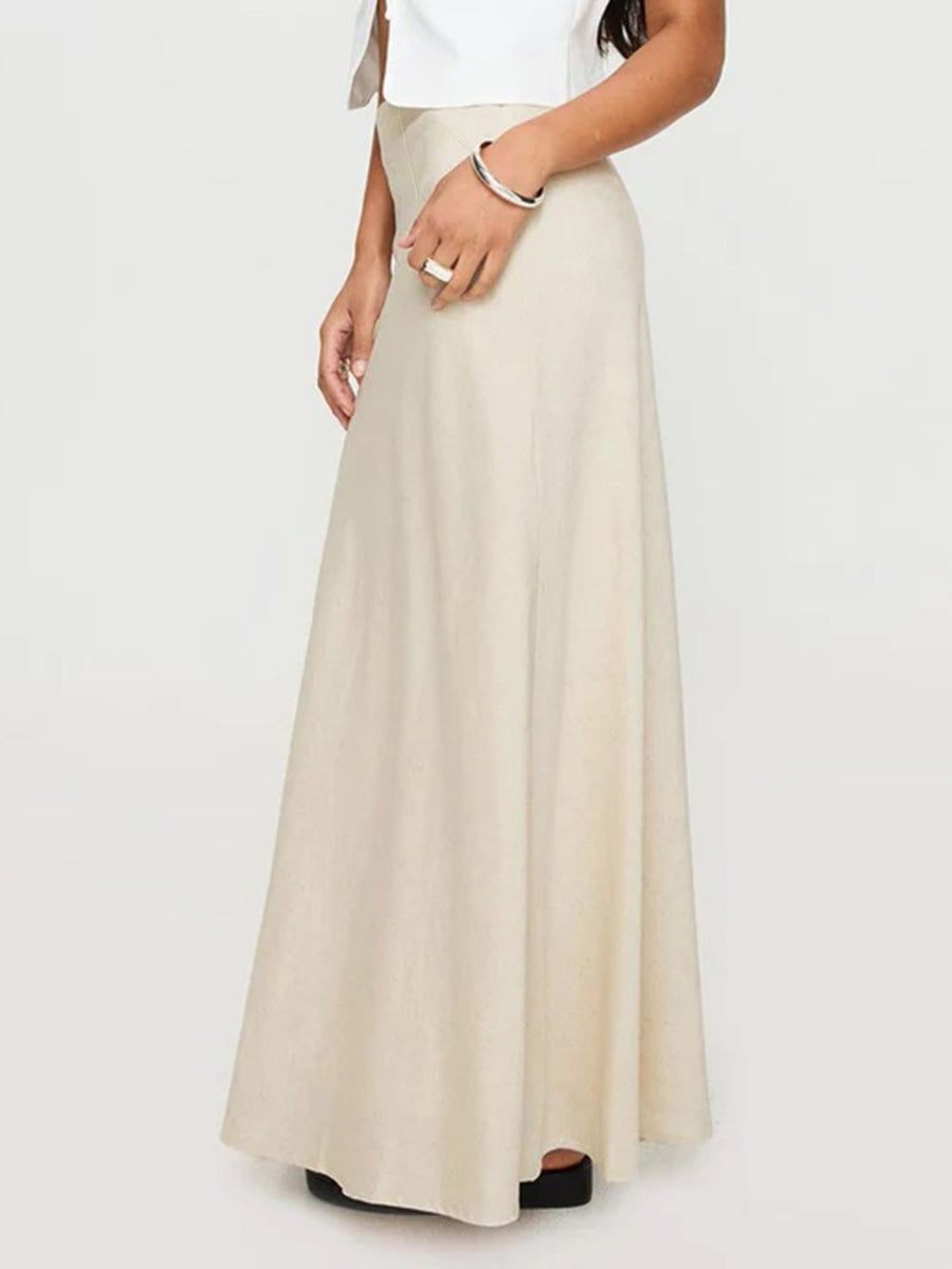 Beige bias-cut maxi skirt with a flowing silhouette.