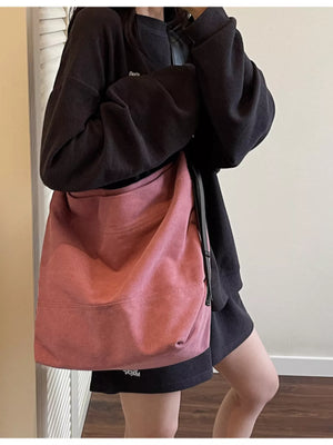 Pink hobo bag with adjustable strap and casual style.