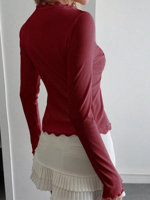 Burgundy ribbed long sleeve top with lace trim neckline and hem.