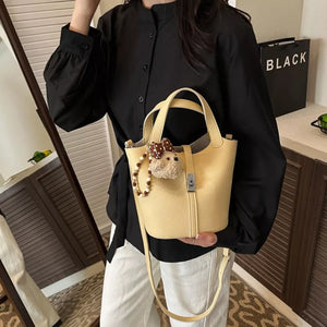 Leather Bucket Crossbody Bag in pale yellow with adjustable strap