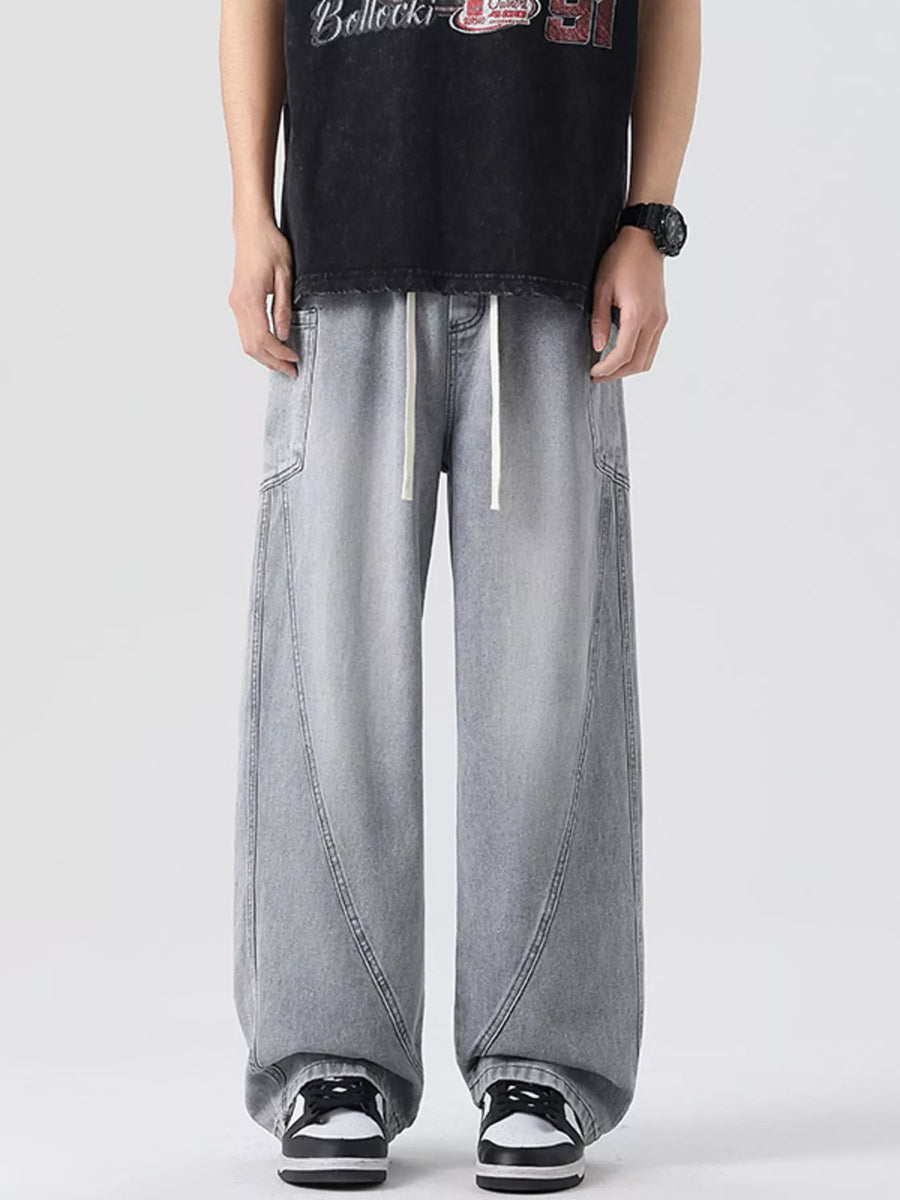 Oversized wide-leg jeans in smoky gray denim with a drawstring waist and vintage-inspired paneling.