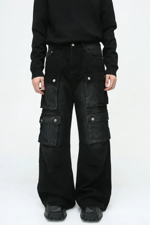 Dark denim wide-leg cargo pants with multiple utility pockets and silver button closures.