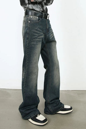 Faded flare denim jeans in dark vintage wash with a relaxed fit.