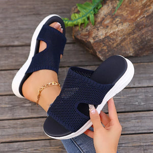 Dark blue mesh slide sandals with open toe and white sole.