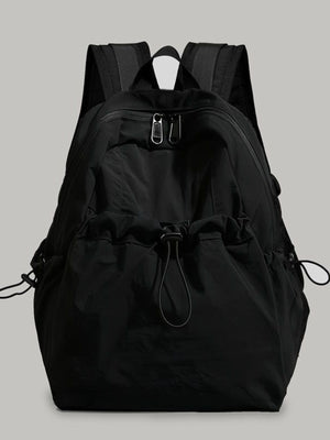 Black lightweight nylon backpack with drawstring closure and adjustable straps.