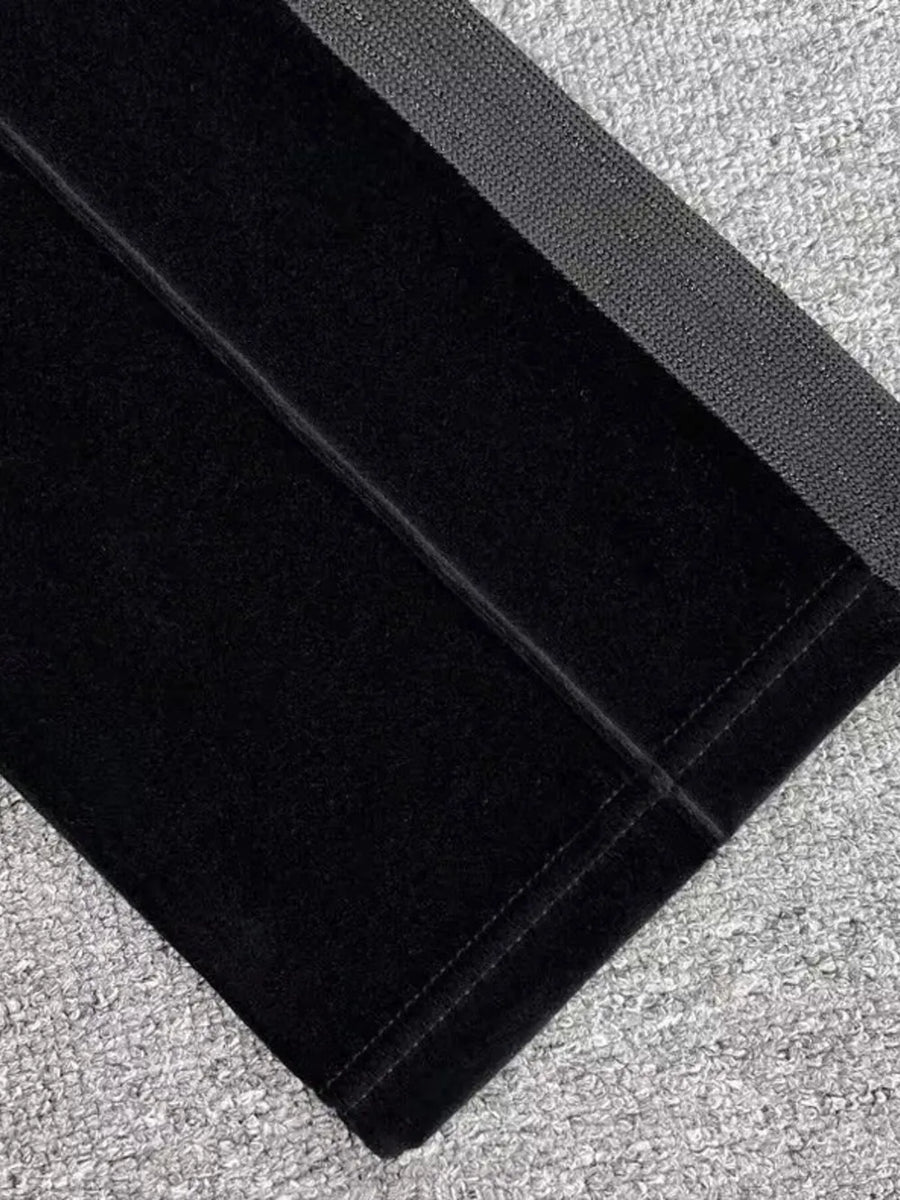 Black velour sweatpants with wide leg and elastic waistband detail.