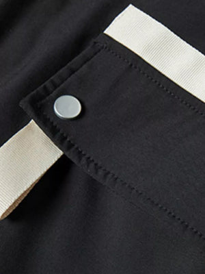 Black jacket with cream trim and silver snap closure