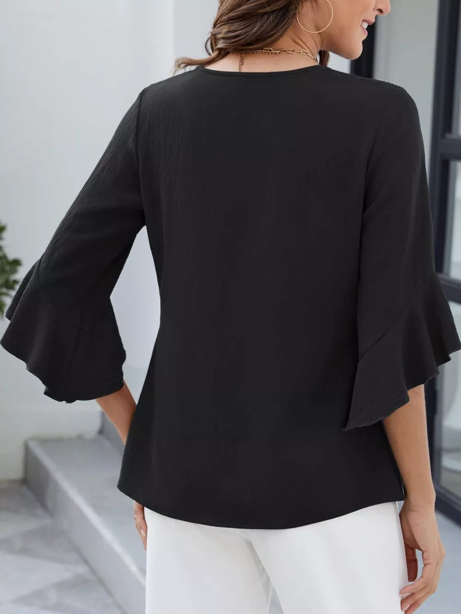 Black V-neck ruffle sleeve blouse with a textured fabric.