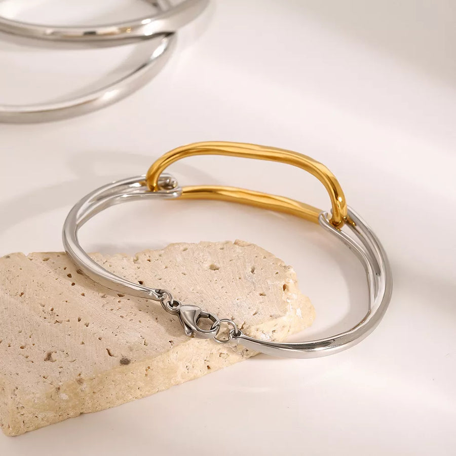 silver bracelet featuring two-tone and geometric