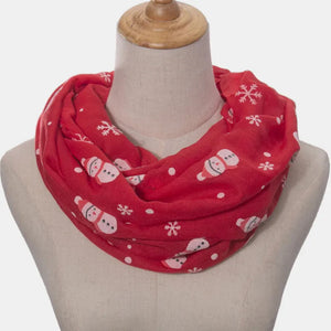 Red infinity scarf with white snowman and snowflake print.