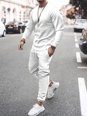Men's white textured loungewear set with crewneck sweatshirt and drawstring pants.