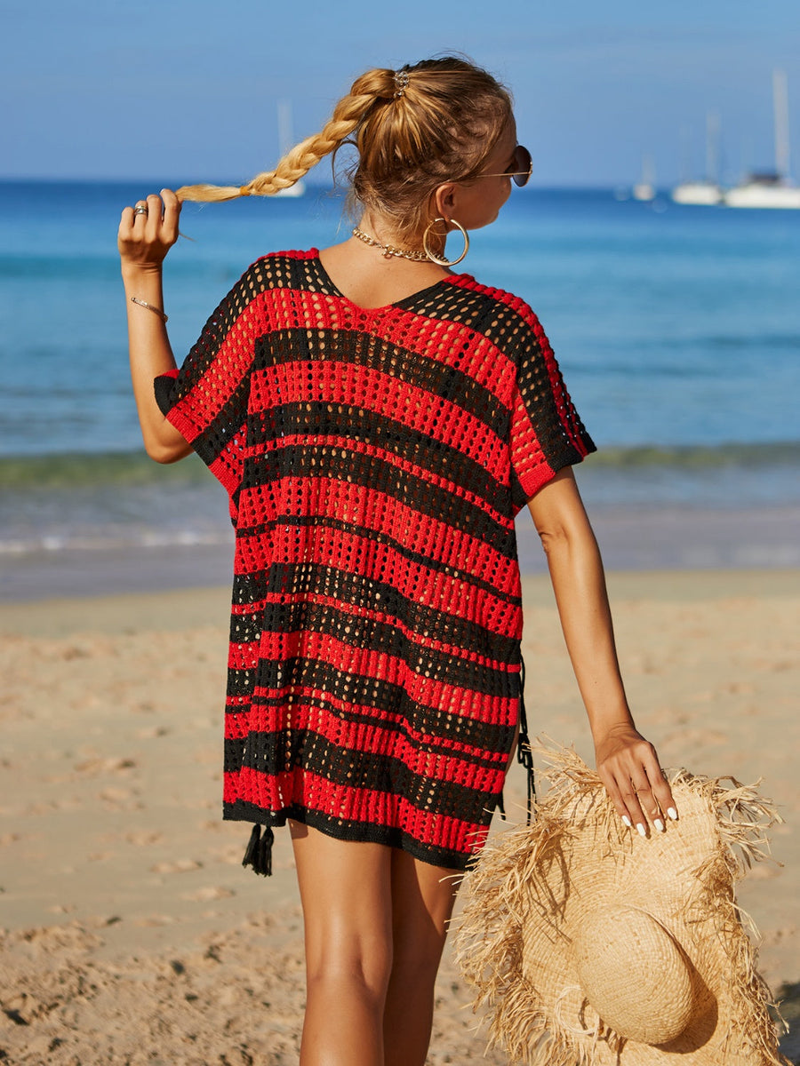 Red and black striped crochet beach cover-up with drawstring sides and tassel hem.