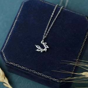 clear necklace featuring zircon embellishment and leaf