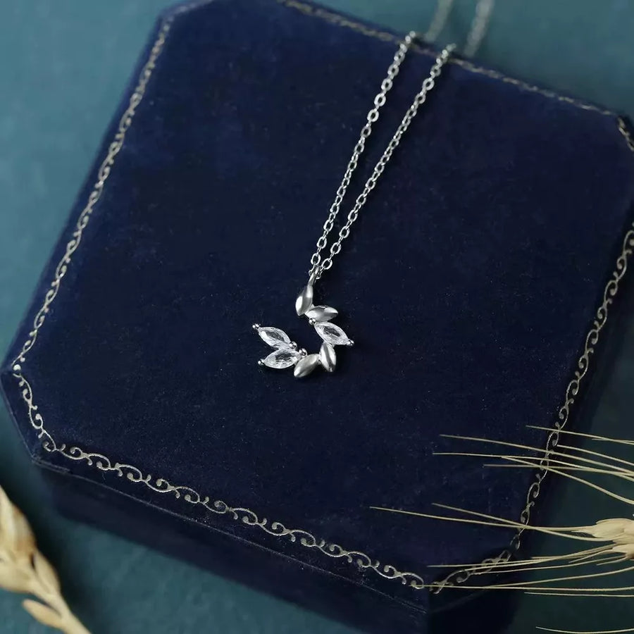 clear necklace featuring zircon embellishment and leaf