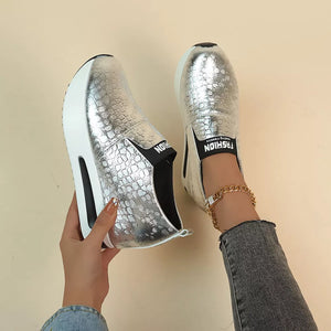 Silver metallic crocodile-embossed platform sneakers with chunky sole and elastic side detail.