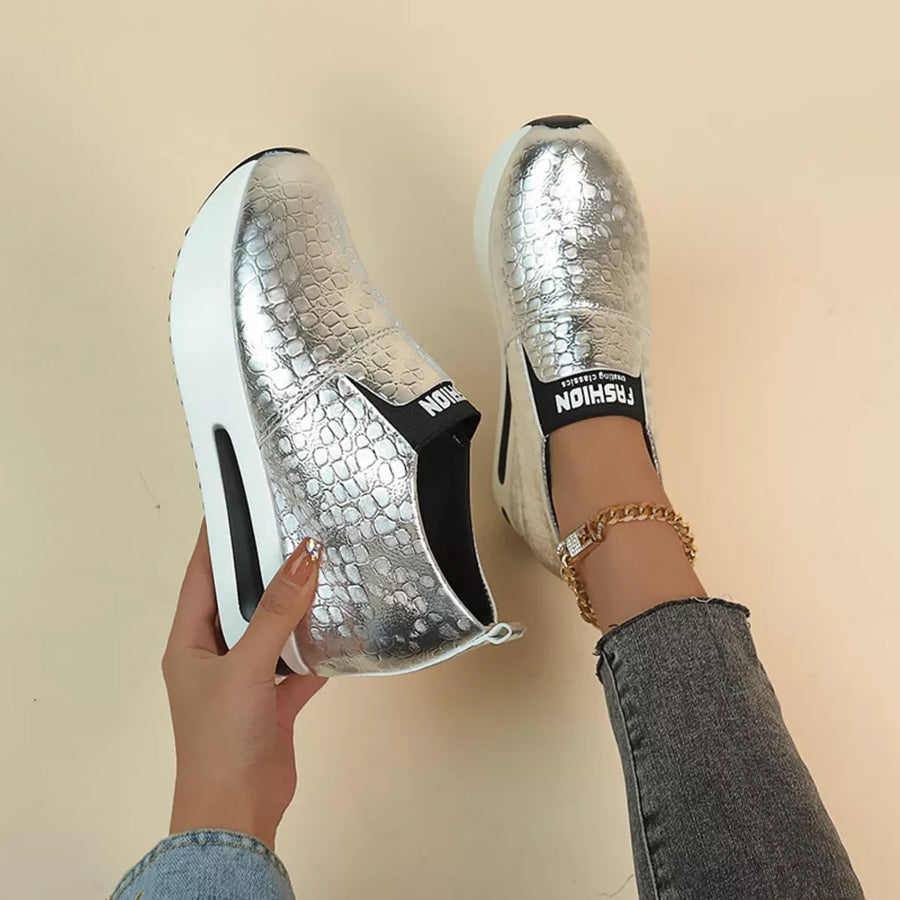 Silver metallic crocodile-embossed platform sneakers with chunky sole and elastic side detail.