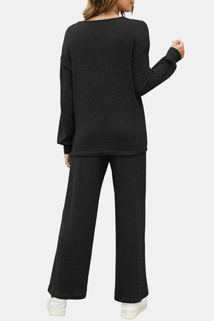 Black ribbed knit lounge set with wide leg pants and long sleeve top.