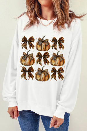 White sweatshirt with a repeating pattern of pumpkins adorned with leopard print bows.