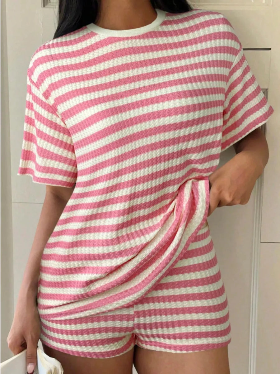 Pink and white striped waffle knit two-piece loungewear set with crew neck top and shorts.